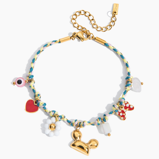Colorful bracelet with gold chain and various charms on a white background