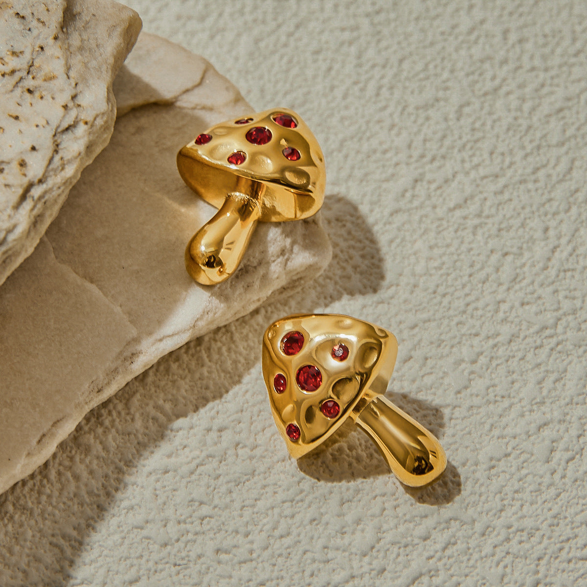 Gold mushroom studs resting on textured stone background