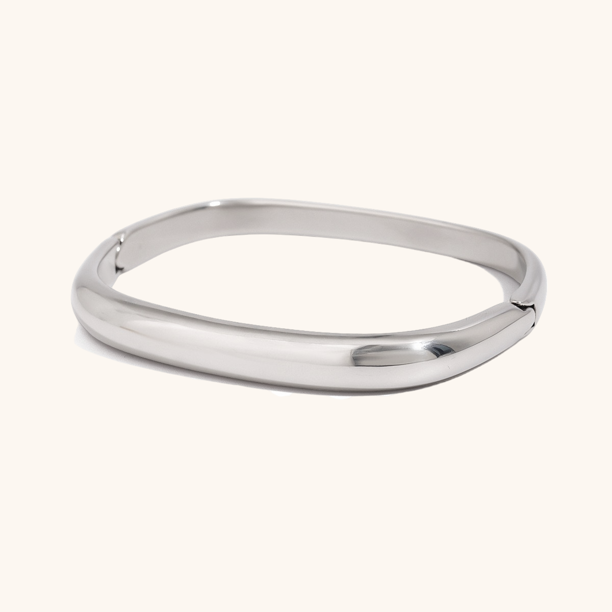 Simple silver cuff bracelet with rounded edge on light background