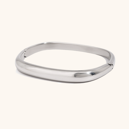 Simple silver cuff bracelet with rounded edge on light background