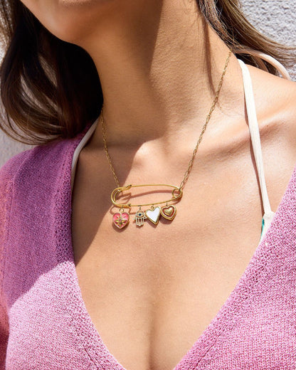 Model wearing statement safety pin necklace with pink top