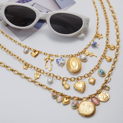 Radiant gold necklace with a heart emblem displayed against a backdrop of summer blooms.