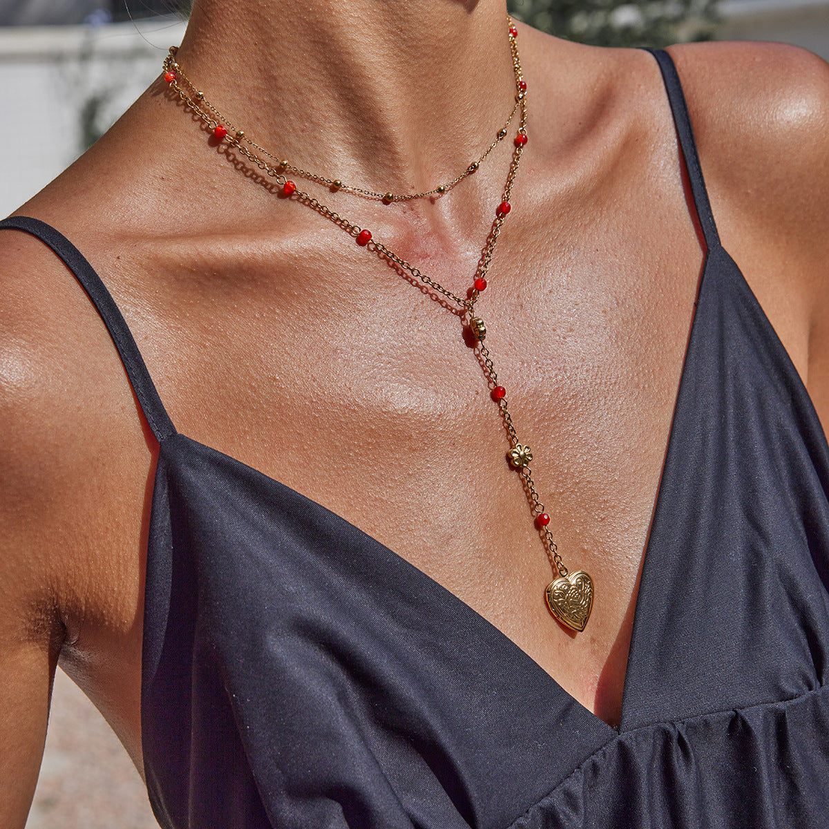 Y-shaped lariat necklace with heart pendant on model