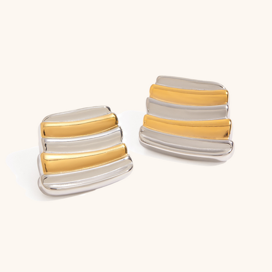 gold and silver striped geometric earrings on white background