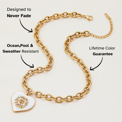 Close-up of gold heart pendant featuring artistic sun face design
