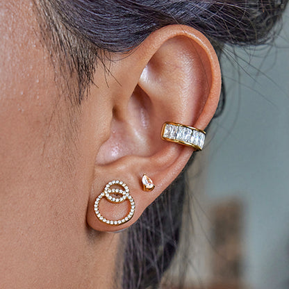 Model wearing reversible pearl and crystal hoop earrings in daylight setting