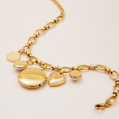 Back view of gold locket bracelet showing polished surface and clasp