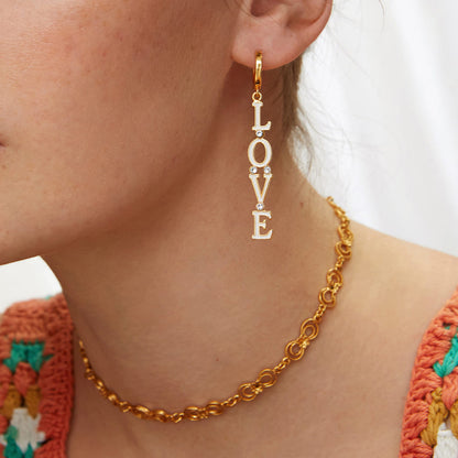 Model wearing golden LOVE earrings, perfect for a flirty daytime look_MiFJewelry