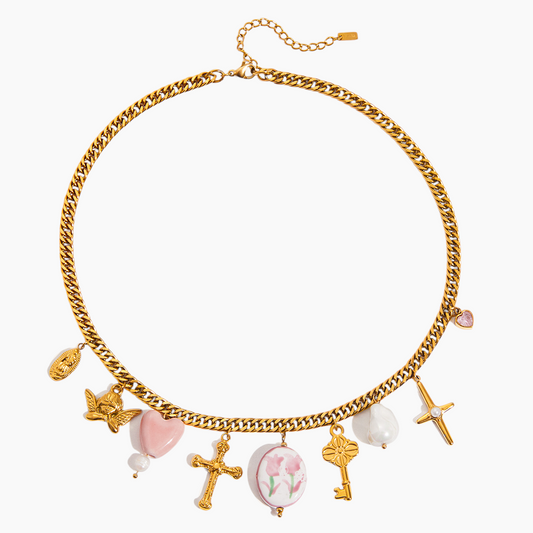 Gold chain necklace with various charms on a white background
