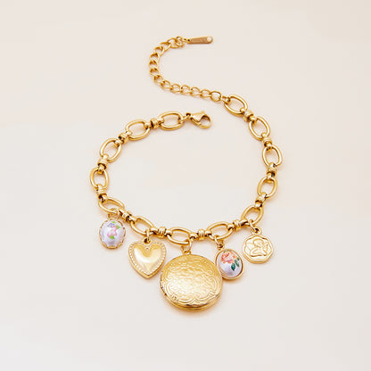 Elegant gold charm bracelet with romantic dangle details