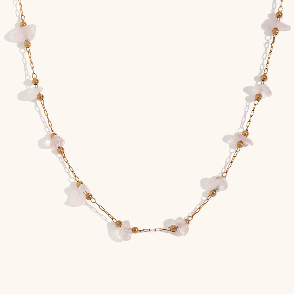 Soft pink rose quartz chip necklace displayed on white background