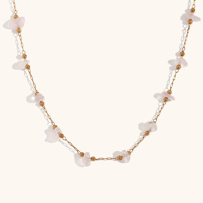 Soft pink rose quartz chip necklace displayed on white background