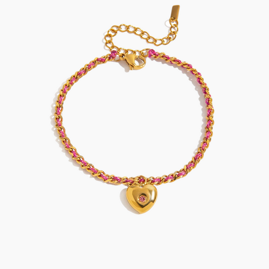 Gold bracelet with pink stones and a heart-shaped clasp on a white background