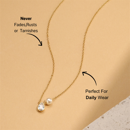 S925 sterling silver teardrop crystal and pearl necklace on beige background