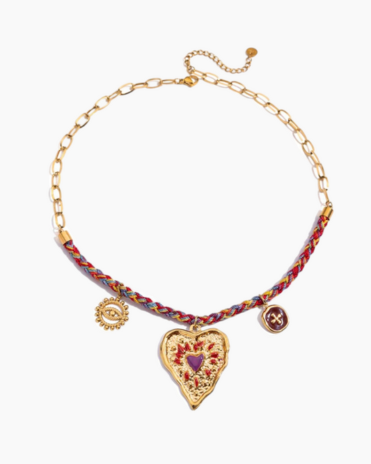Necklace with heart-shaped pendant and braided multicolor cord on a white background