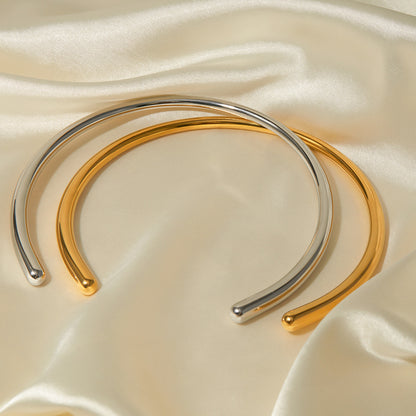 Sculptural gold open choker with rounded ends, contemporary jewelry