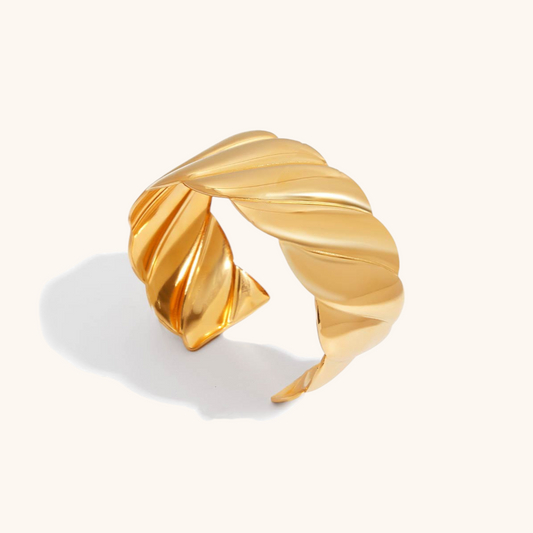 Studio shot of sleek gold Aurora Twist Cuff, perfect for women seeking bold statement jewelry.