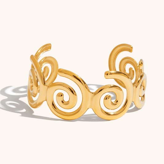 Artistic spiral bracelet in shiny gold finish shot from side view