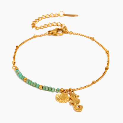 Close-up of Seahorse Serenity Bracelet with gold seahorse charm and ocean-inspired textures