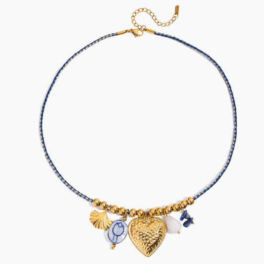 Necklace with heart-shaped charm and blue beads on a white background