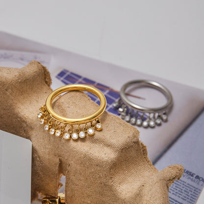 Stackable gold and silver rings with hanging crystals