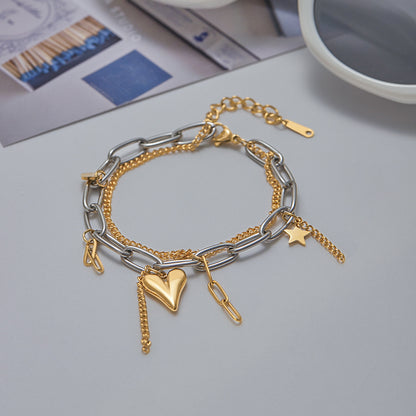 Two-tone bracelet laid out next to lifestyle objects