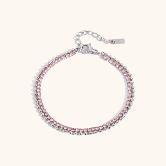 Silver bracelet with dual-row pink crystals, laid out on neutral backdrop