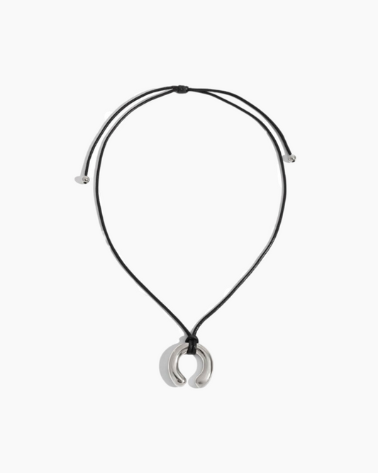 Necklace with a crescent moon pendant on a white background