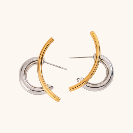 Flatlay of gold and silver hoop earrings with fashion-forward twist design