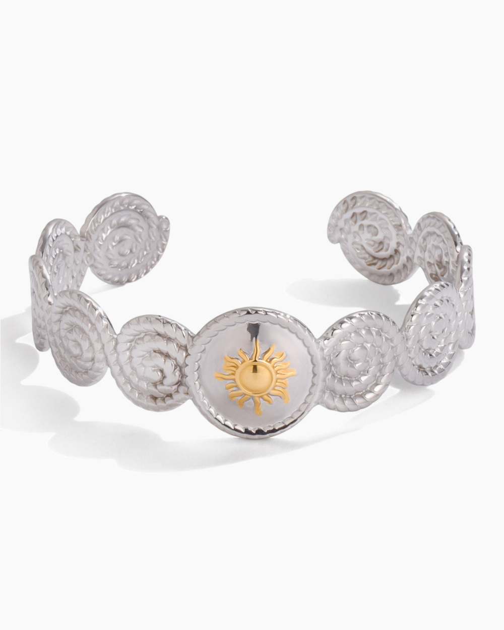 Silver bracelet with a sun emblem on a white background