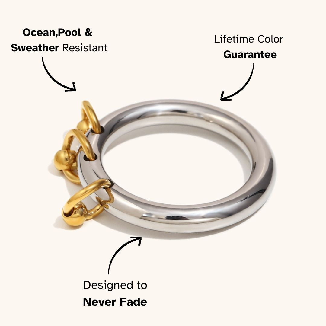 Two-tone ring featuring polished silver band and gold dangle details, trendy and durable