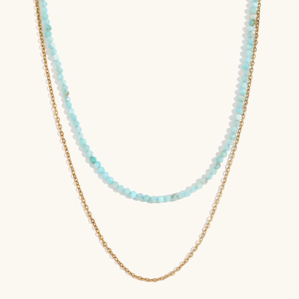 Pastel blue layered crystal necklace with shimmering gold chain detail