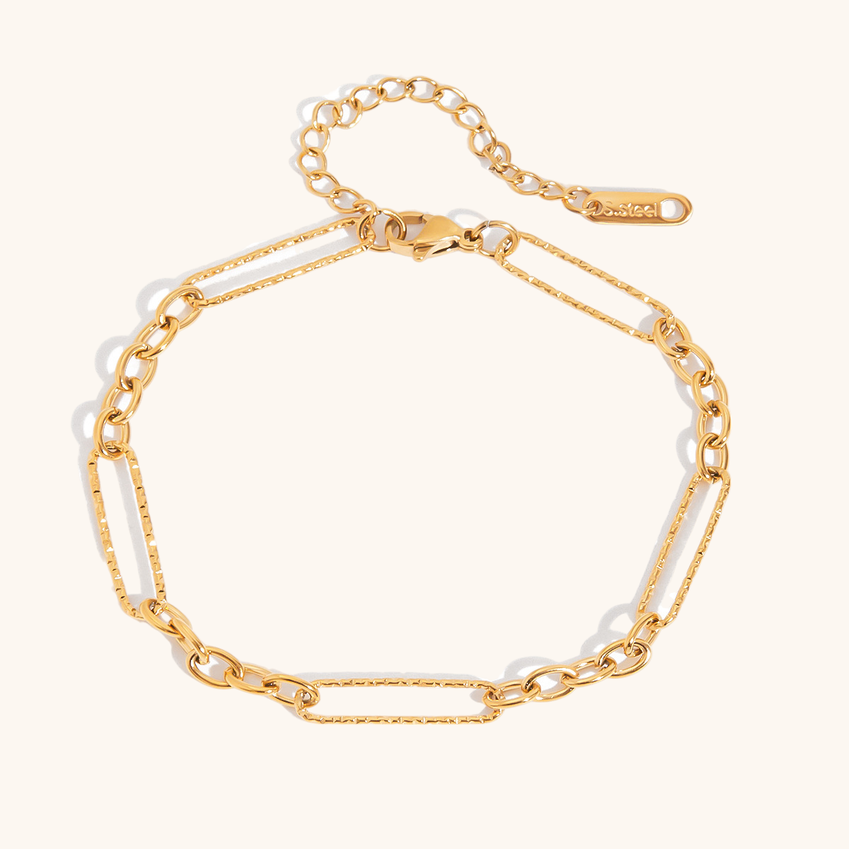 Close-up of sleek gold link chain bracelet on white background.