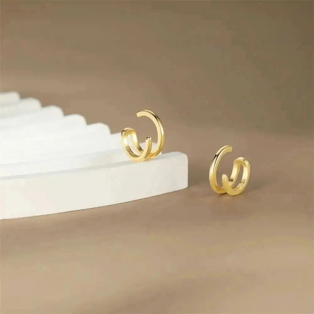 Sleek Gold Ear Cuffs - These polished gold ear cuffs are the perfect blend of simplicity and style. Ideal for those looking to add a subtle shine to any outfit.