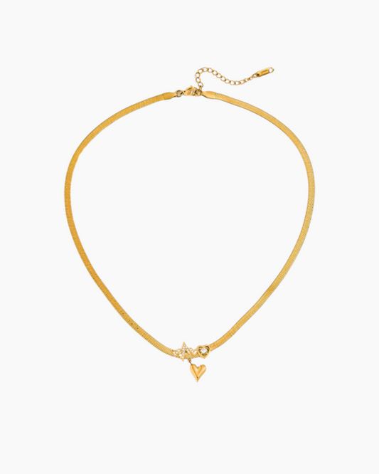 Gold necklace with a small triangle pendant on a white background