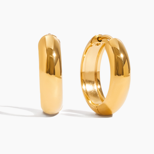 Pair of gold hoop earrings on a white background