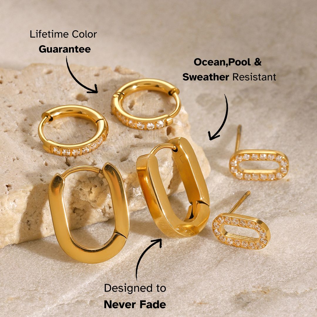 Modern U-shaped chunky gold hoop earrings placed on neutral backdrop