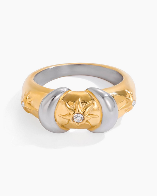 Two-tone gold and silver ring with floral design and diamond on a white background