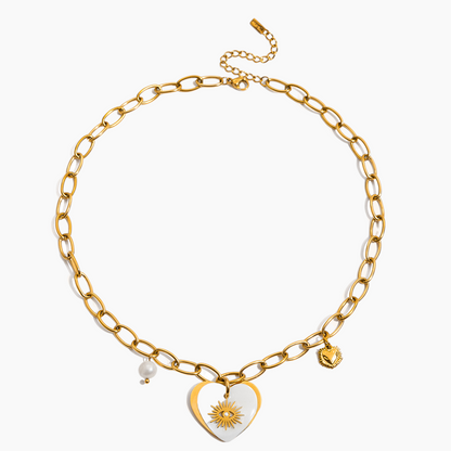 Gold chain necklace with heart-shaped pendant and sun design on a white background