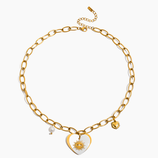 Gold chain necklace with heart-shaped pendant and sun design on a white background