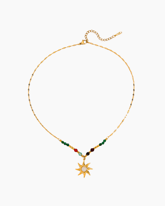 Necklace with a sun pendant and colorful beads on a white background