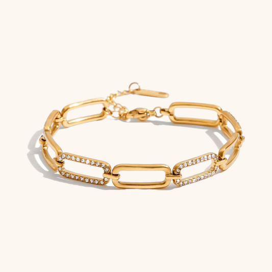 Flat lay of glittering link chain bracelet with white background