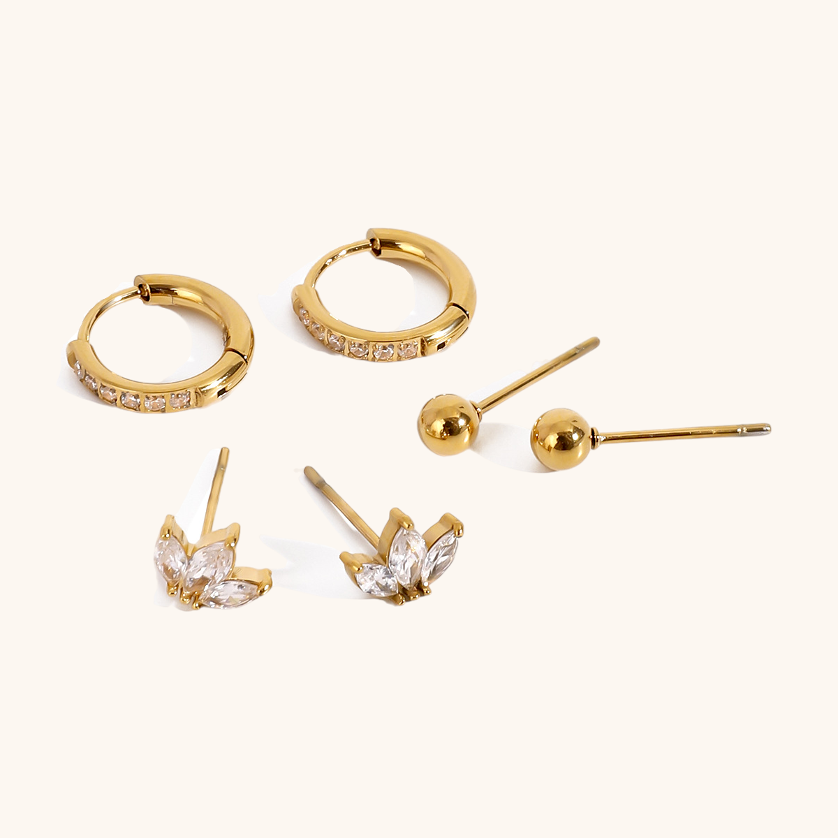 gold hoop earrings with pave zircon on white background