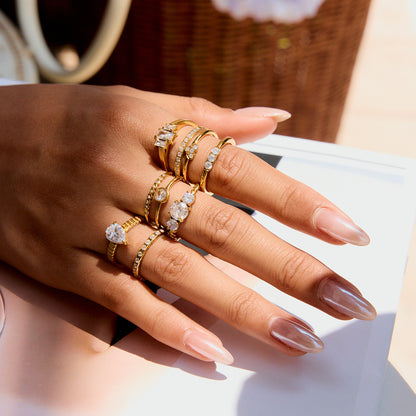 Close-up of gold rings with sparkling zirconia on hand under sunlight