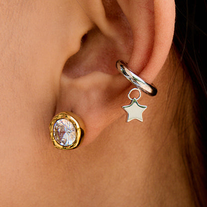 Model wearing chunky gold crystal studs in natural daylight
