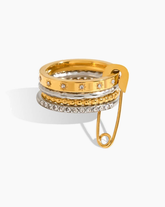 Gold and silver ring with a decorative clasp on a white background