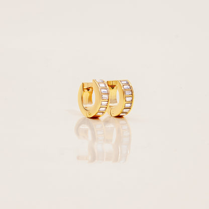 Close-up of waterproof gold crystal hoops with clear stones