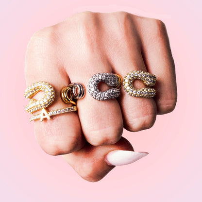 Lustre spiral ring styled with slim stacking bands on finger.