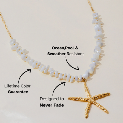 Close-up of white beaded necklace with textured gold starfish pendant on cream background