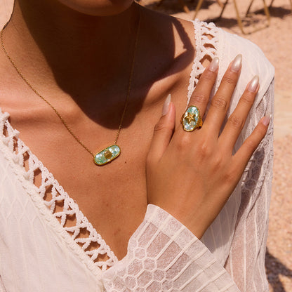 Close-up of model wearing starfish resin ring with matching shell necklace
